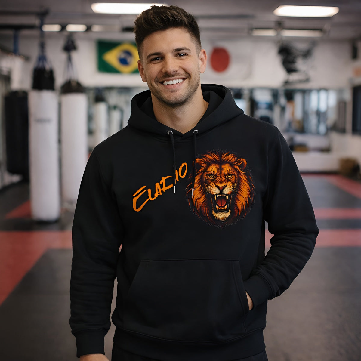 Alt Tag: Lion Personalized Marcial Arts Premium Unisex Hoodie negra con diseño de león y nombre, usada por hombre en gimnasio de artes marciales
