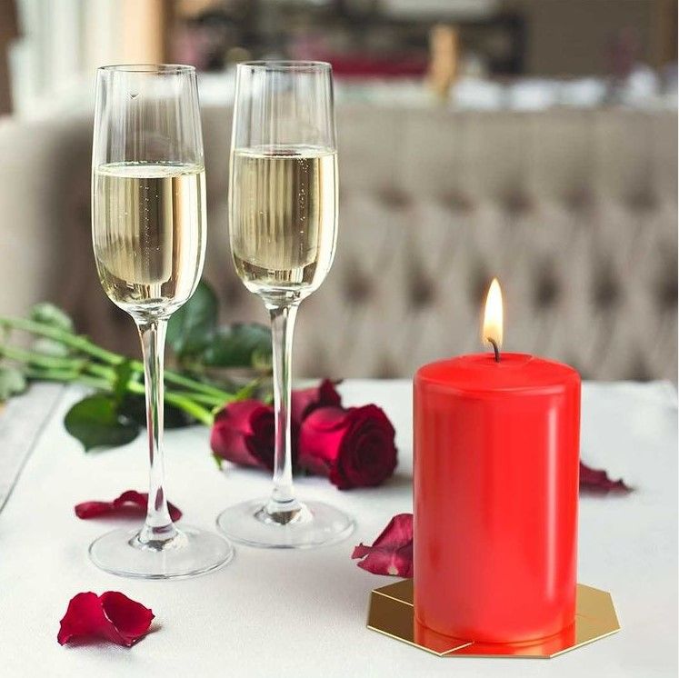 Alt Tag: Luxurious Parafin Pillar Candle – 60x100MM Red lit red pillar candle on table with champagne flutes and roses
