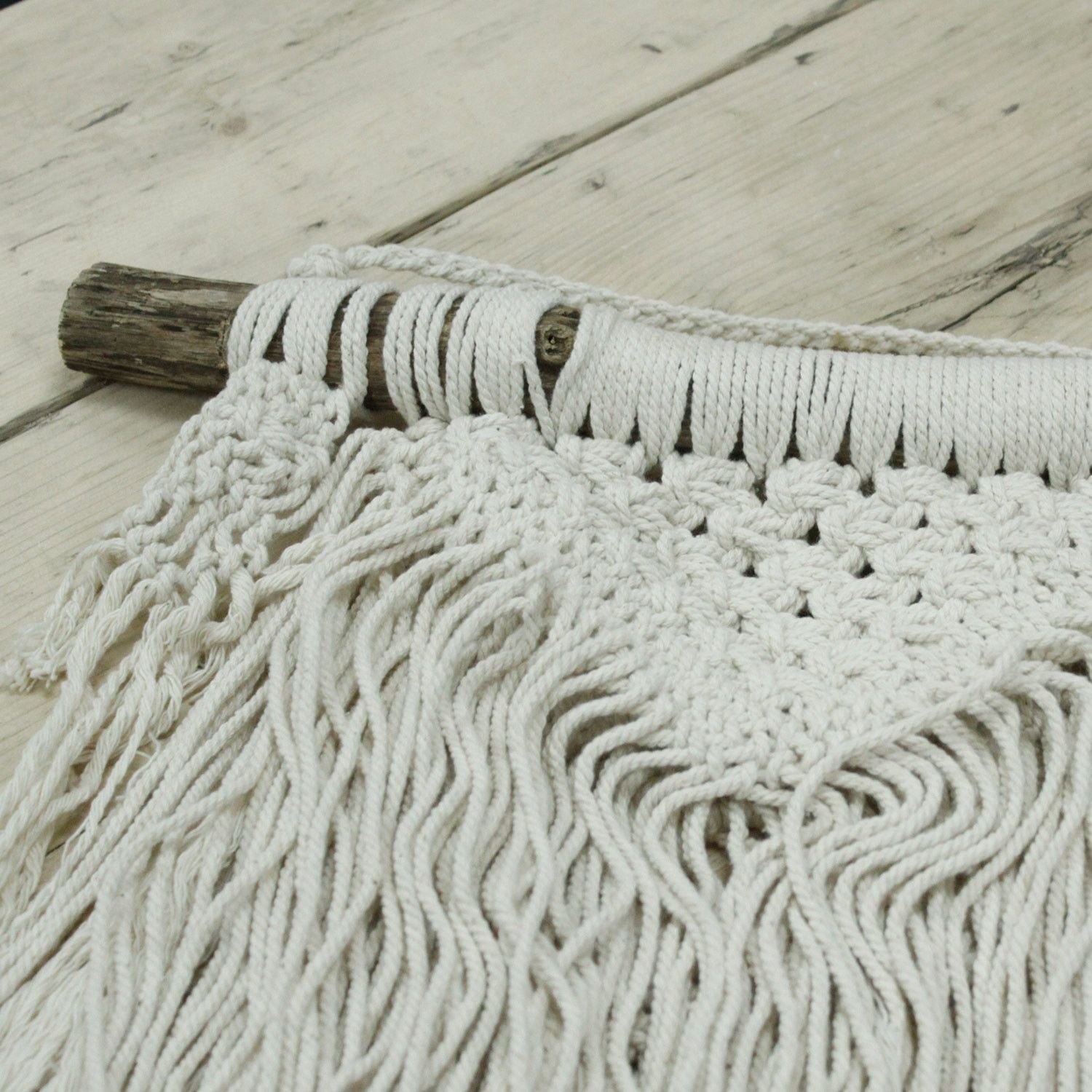 Alt Tag: Macramé Wall Hanging – Natural Abundance in natural cotton with fringe and knotted detail on rustic wooden dowel