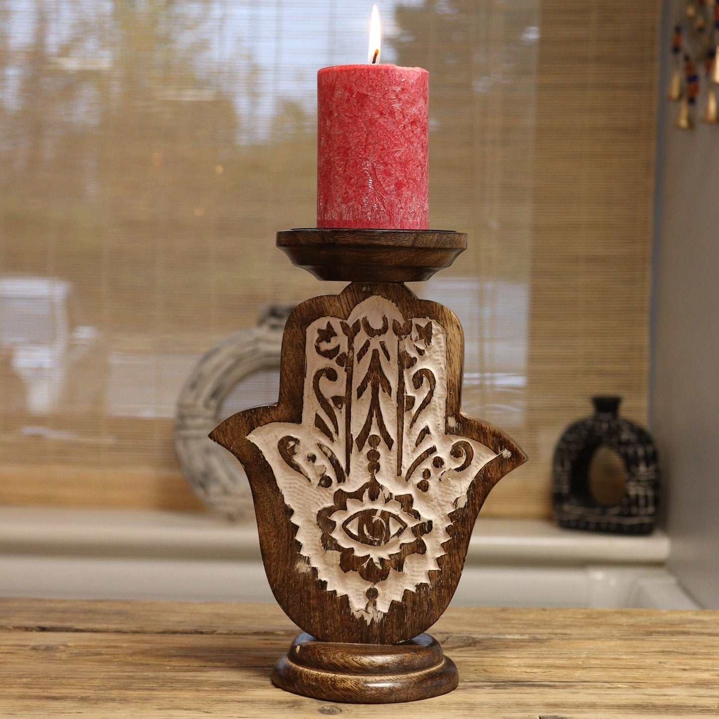 Mango Wood Candle Stand – Hamsa Design (Small, 18 × 11 CM) hand-carved holder with red pillar candle on wooden tabletop