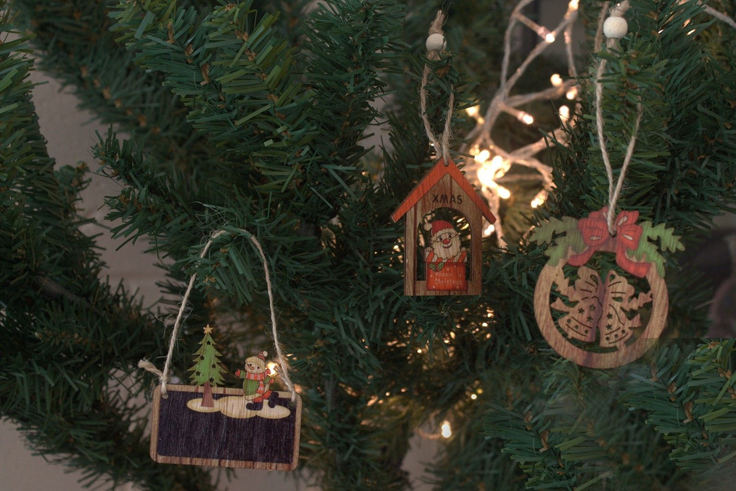 Alt Tag: MDF Christmas Décor – Snowman & Tree Set wooden ornaments hanging on Christmas tree with lights, snowman and tree designs