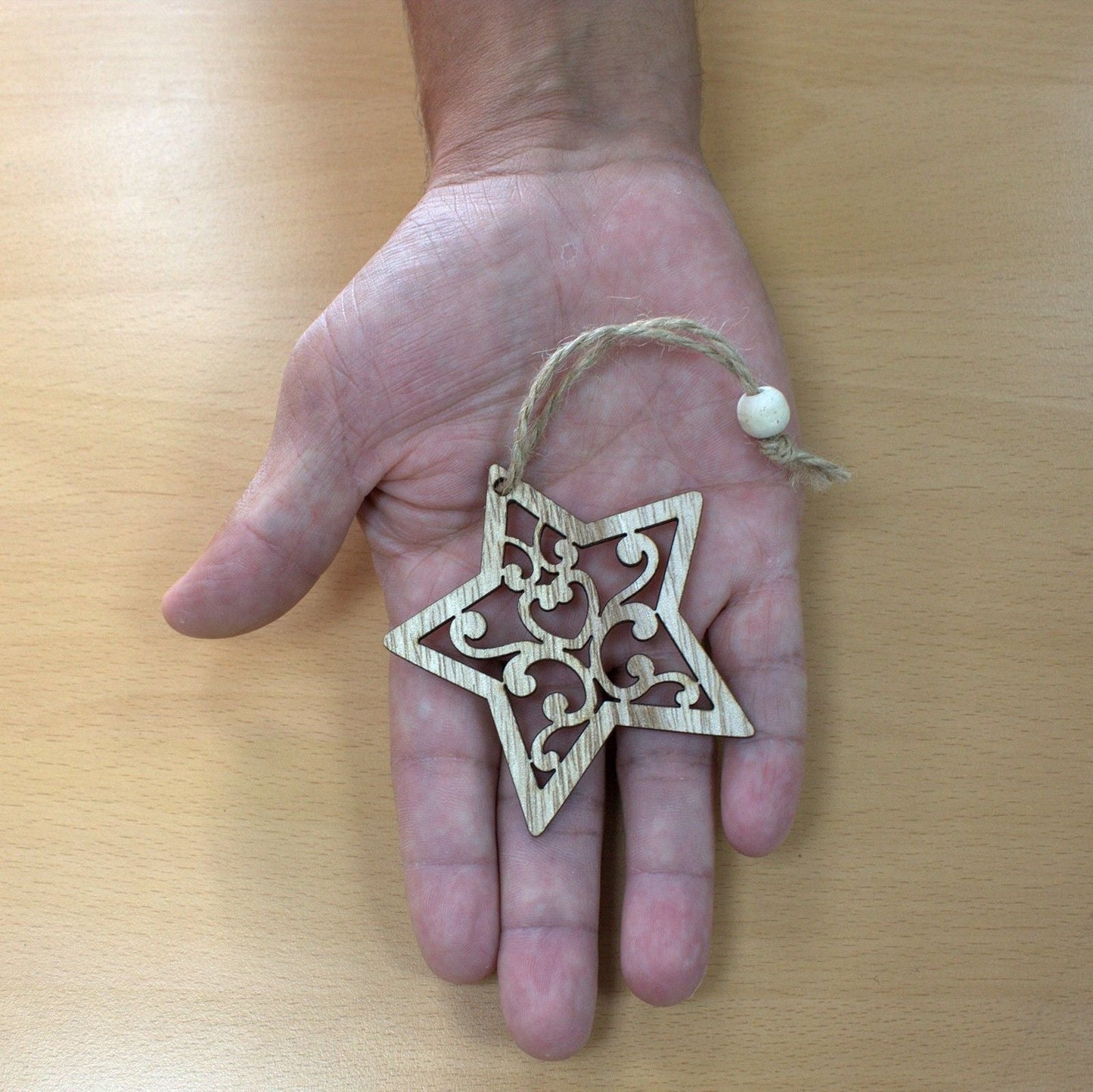 Alt Tag: MDF Christmas Décor – Snowman & Tree Set wooden star ornament with twine, shown in hand for size