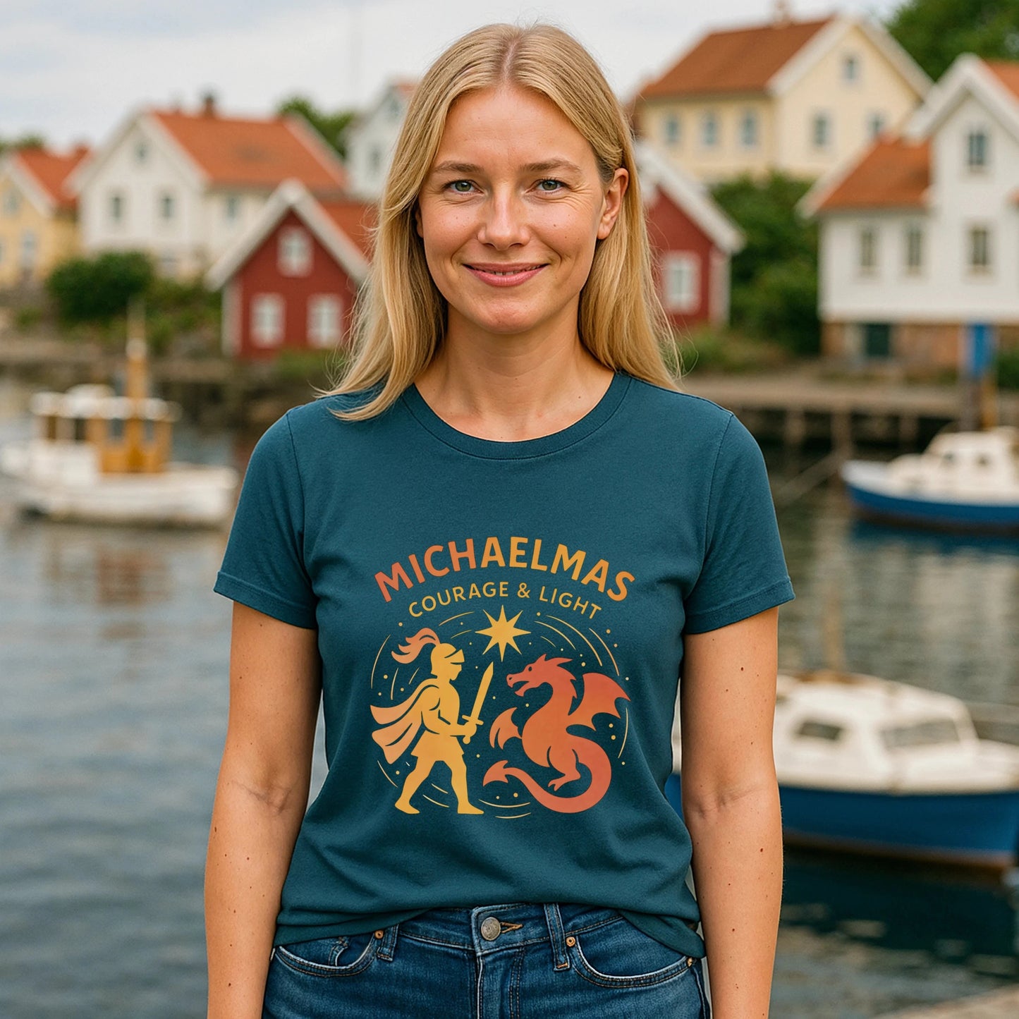 Alt Tag: Michaelmas Courage Ans Light 100% Organic Cotton T-Shirt worn by woman, teal tee with Michaelmas Courage & Light graphic, harbor backdrop