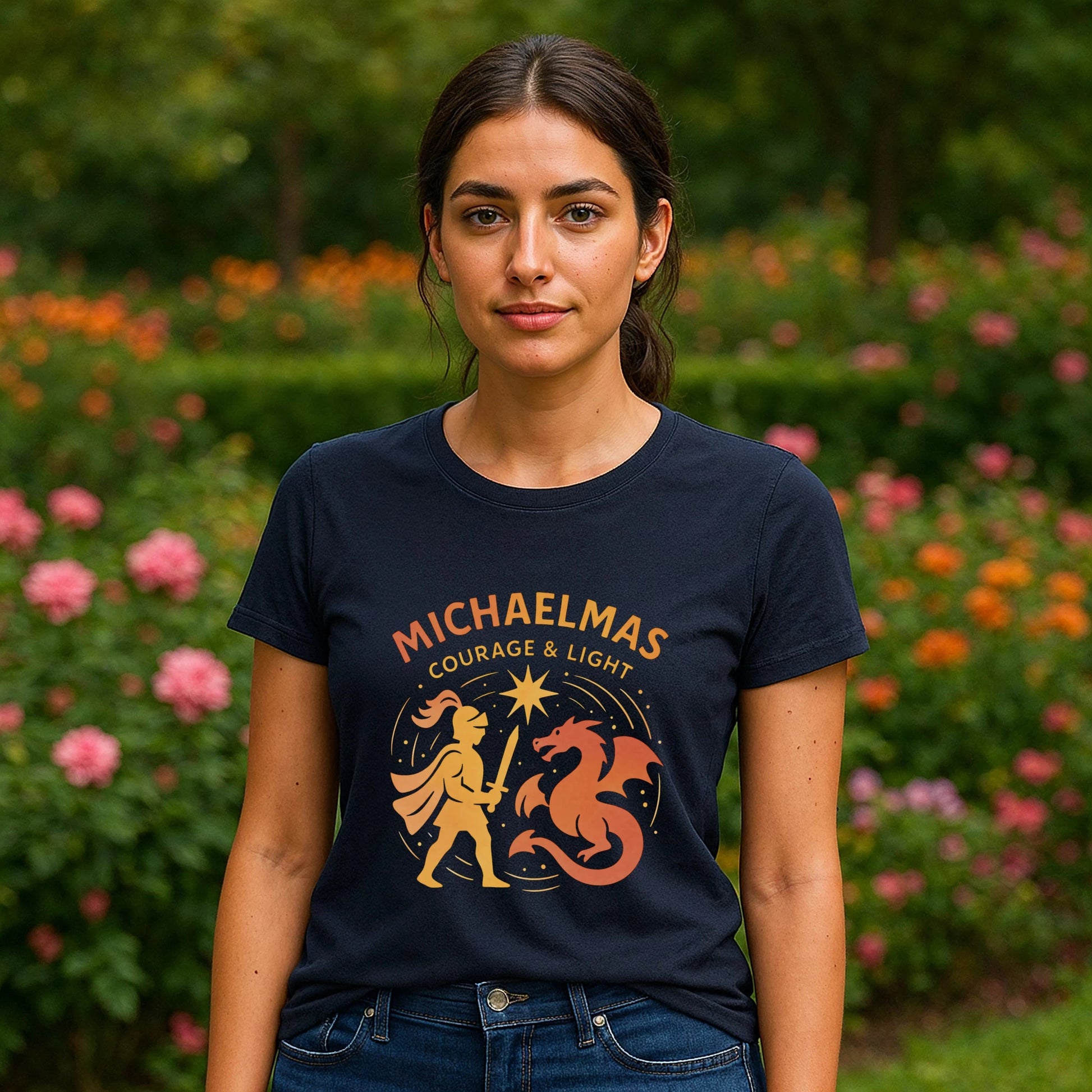 Alt Tag: Mujer usando Michaelmas Courage Ans Light 100% Organic Cotton T-Shirt azul marino con gráfico "Michaelmas" y dragón, en jardín