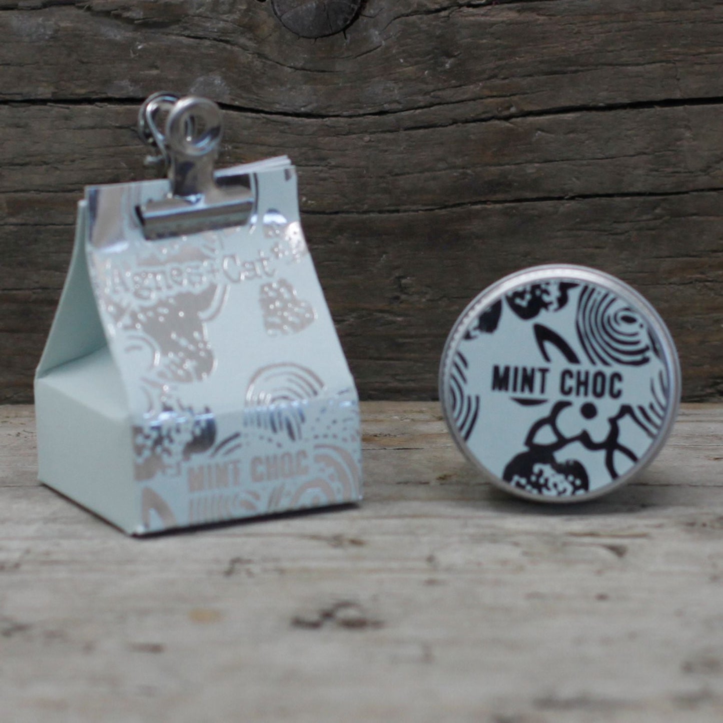 Alt Tag: Mint Chocolate Vegan Lip Balm – 12G tin with mint choc label and packaging on rustic wooden background