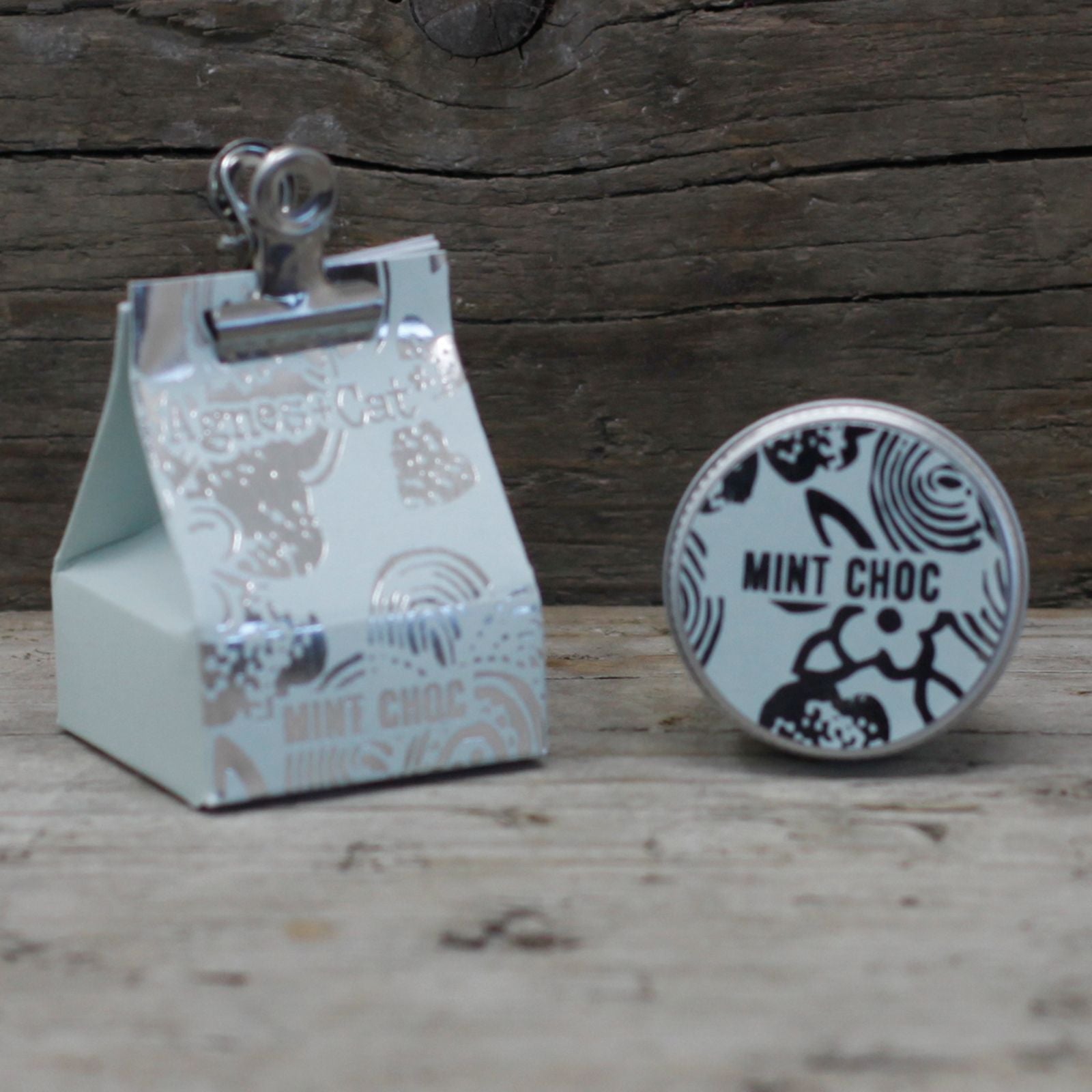 Alt Tag: Mint Chocolate Vegan Lip Balm – 12G tin with mint choc label and packaging on rustic wooden background