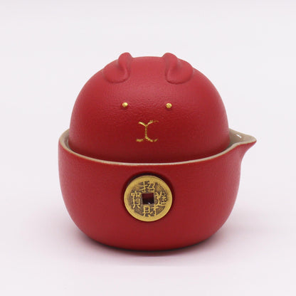 Alt Tag: Money Cat Teapot Set – Two Cups – Travel Pack – Red, red ceramic maneki neko cat teapot with coin detail, compact travel tea set