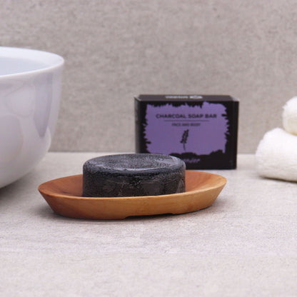 Naseberry Wood Soap Dish – Oval 7x3 CM holding round charcoal soap bar on bathroom counter with towel