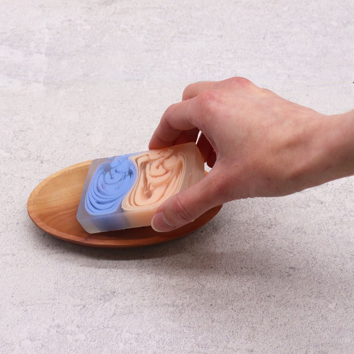 Alt Tag: Naseberry Wood Soap Dish – Oval 7x3 CM oval mahogany soap dish with drainage, hand placing soap bar on wooden tray