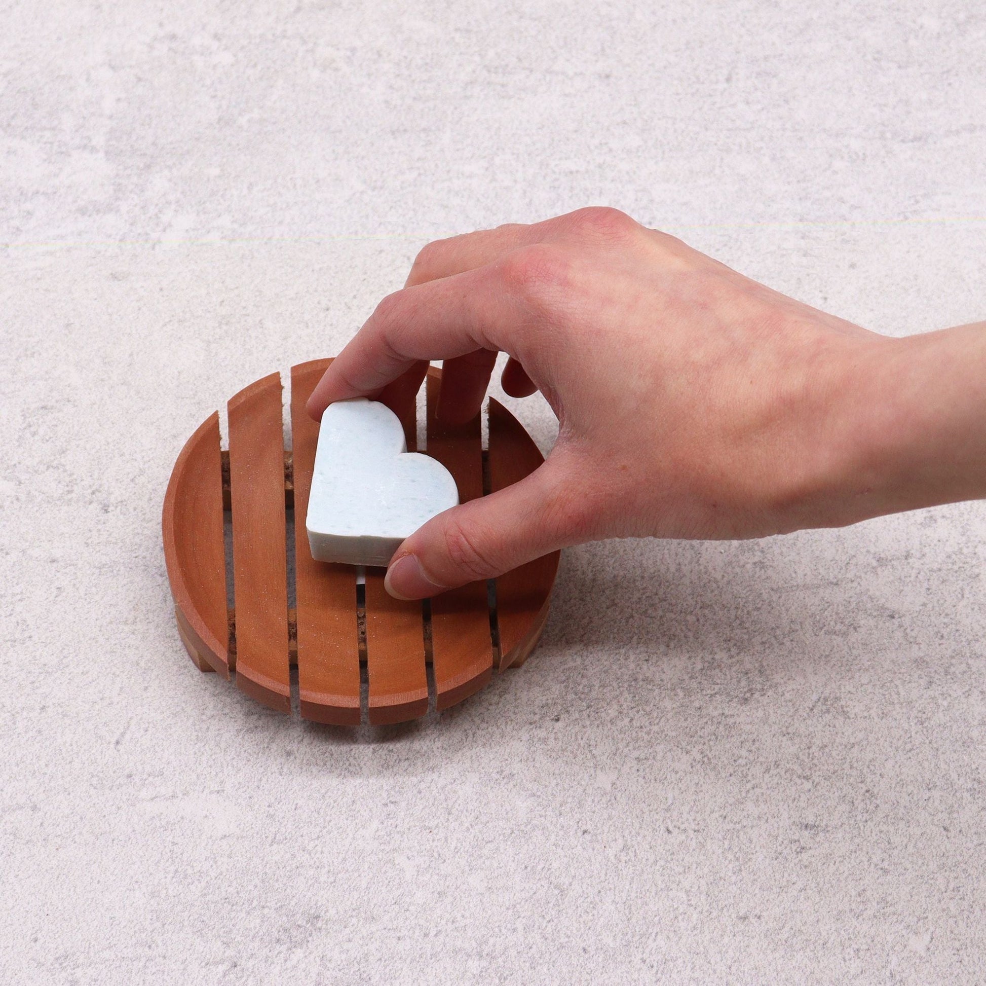 Naseberry Wood Soap Dish – Round 10x2 CM with drainage slots, hand placing white bar soap on round wooden dish