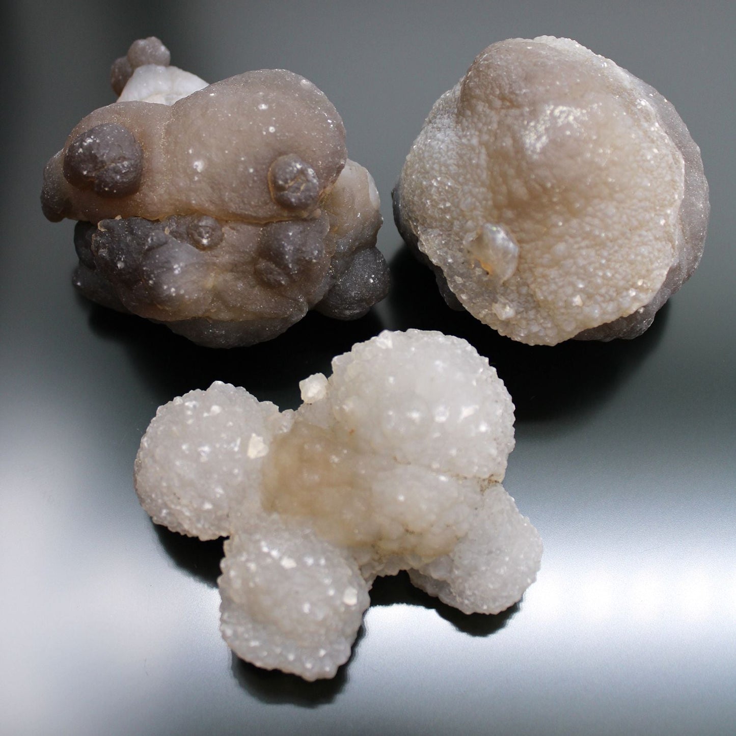 Alt Tag: Natural Chalcedony Mineral Specimens – 100-Piece Set, close-up of three raw chalcedony mineral specimens with druzy texture