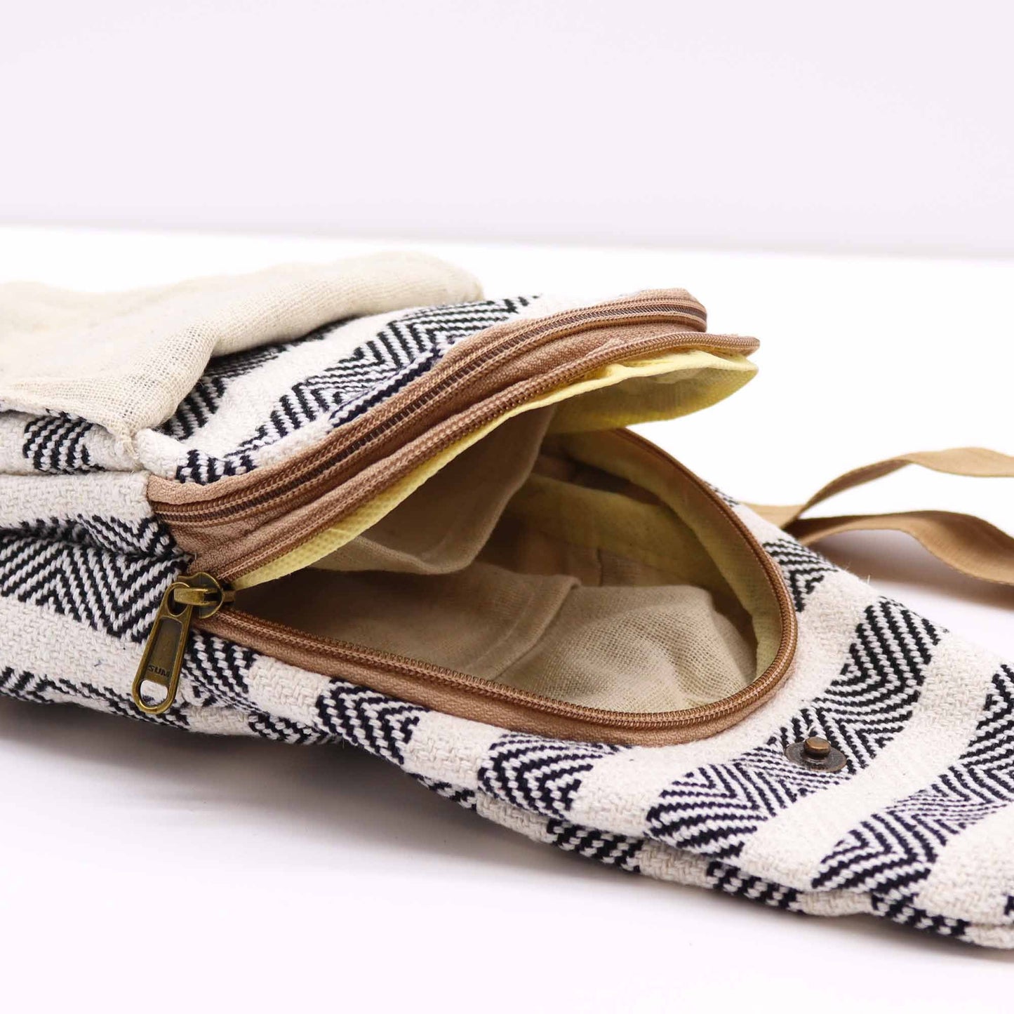 Natural Cotton Cross Body Bag – Black & White open zipper detail showing cotton-lined interior and black-and-white woven pattern