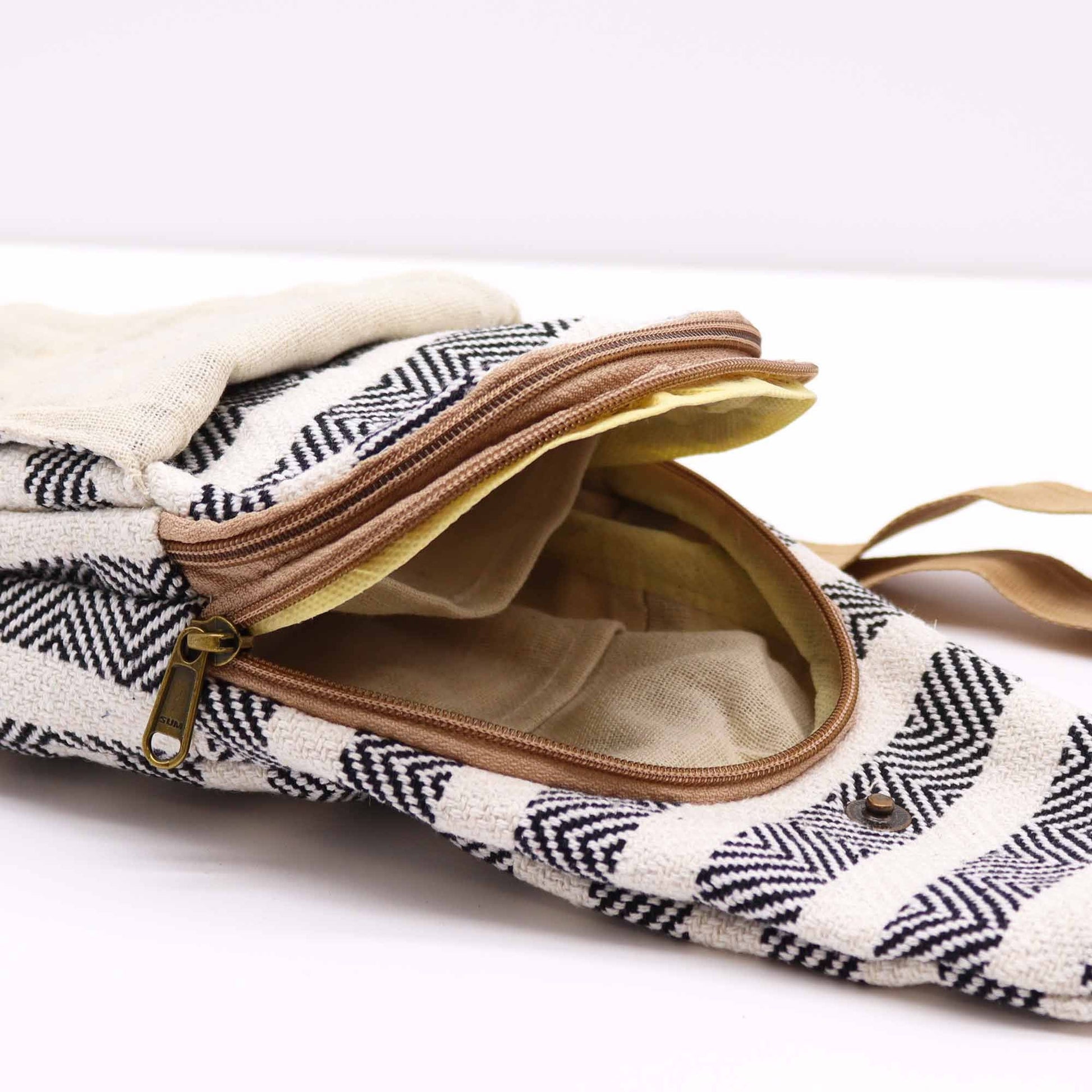 Natural Cotton Cross Body Bag – Black & White open zipper detail showing cotton-lined interior and black-and-white woven pattern
