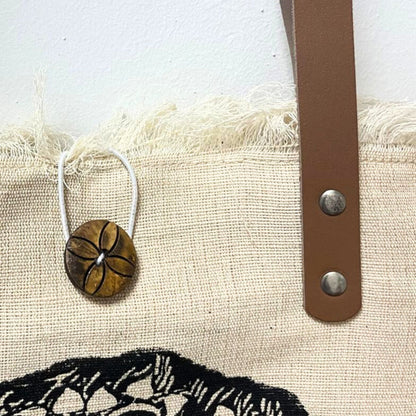 Alt Tag: Natural Cotton Tote Bag with Leather Handle – Mandala close-up of natural cotton fabric, leather strap with rivets and mandala print