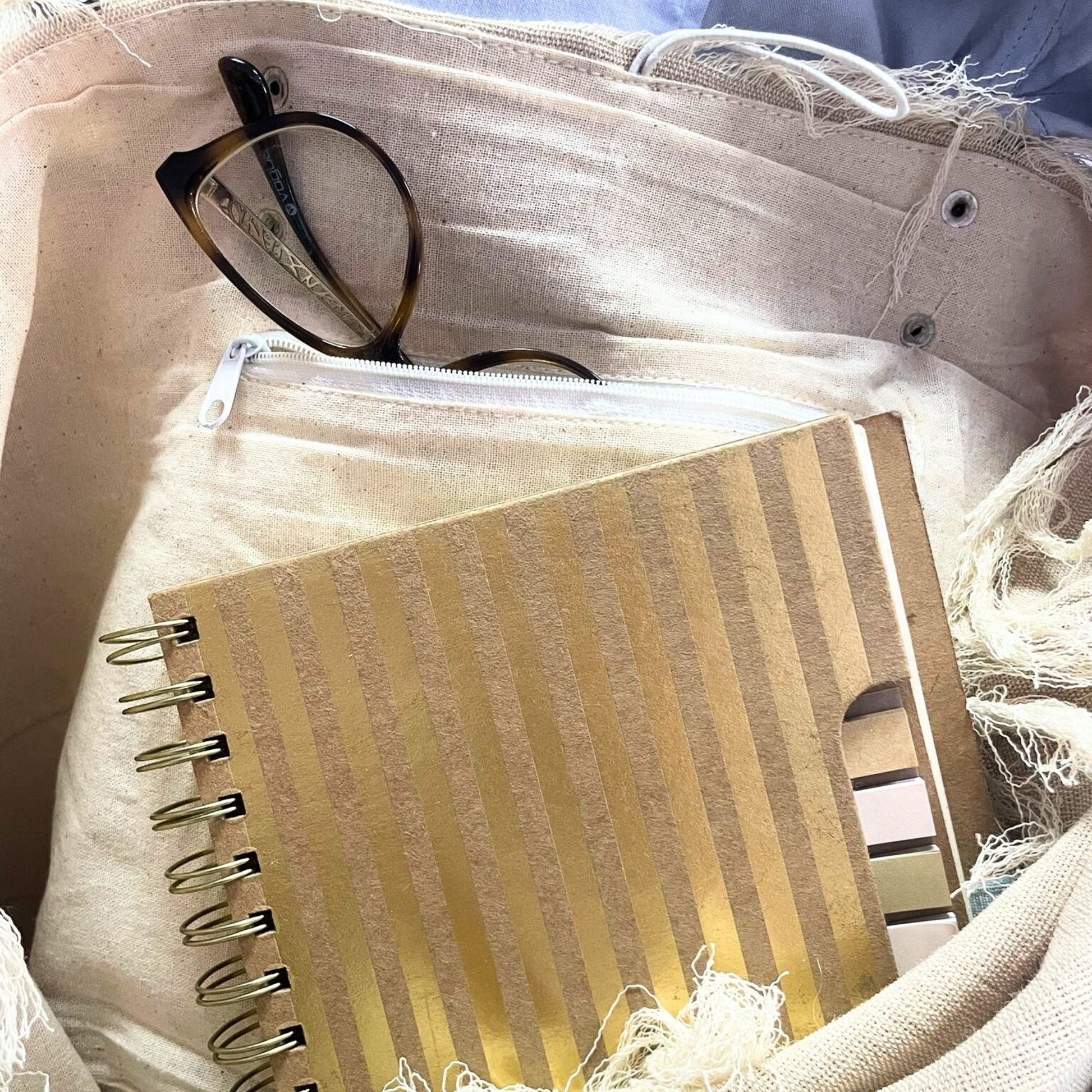 Alt Tag: Natural Cotton Tote Bag with Leather Handle – Mandala interior with zip pocket holding glasses and gold striped notebook