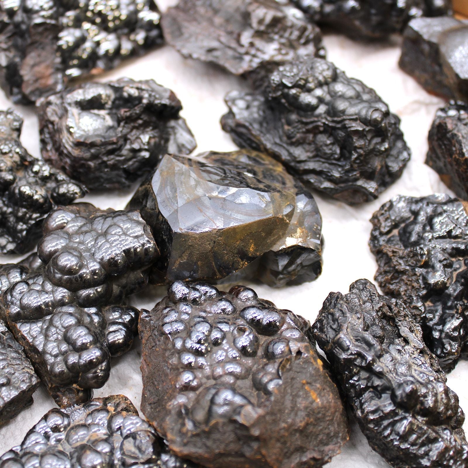 Alt Tag: Natural Hematite Mineral Specimens – Approx 20 Pieces, metallic black hematite rock specimens with natural texture on white background
