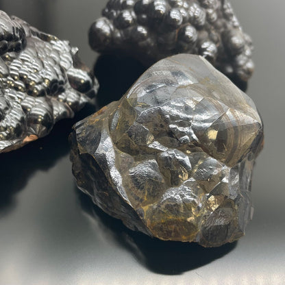 Natural Hematite Mineral Specimens – Approx 20 Pieces close-up of metallic black hematite mineral chunks with shiny texture