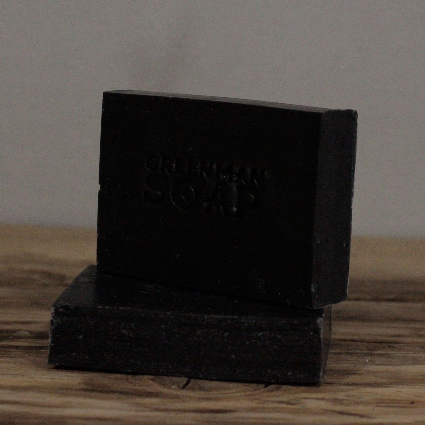 Alt Tag: Natural Spicy Scent Greenman Soap – 100G black handmade bar soap with clove, sage and activated charcoal on wooden surface
