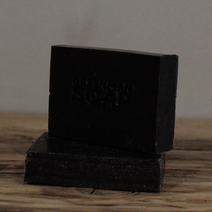 Alt Tag: Natural Spicy Scent Greenman Soap – 100G black handmade bar soap with clove, sage and activated charcoal on wooden surface