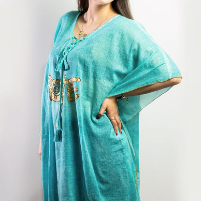 Nomad Sari Kaftan – Turquoise & Gold Love Design turquoise beach kaftan with gold LOVE motif, relaxed drape