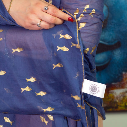 Alt Tag: Nomad Sari Pario – Sea Blue & Gold Fish Design sea blue sheer fabric with gold fish motif and gold trim, worn as wrap