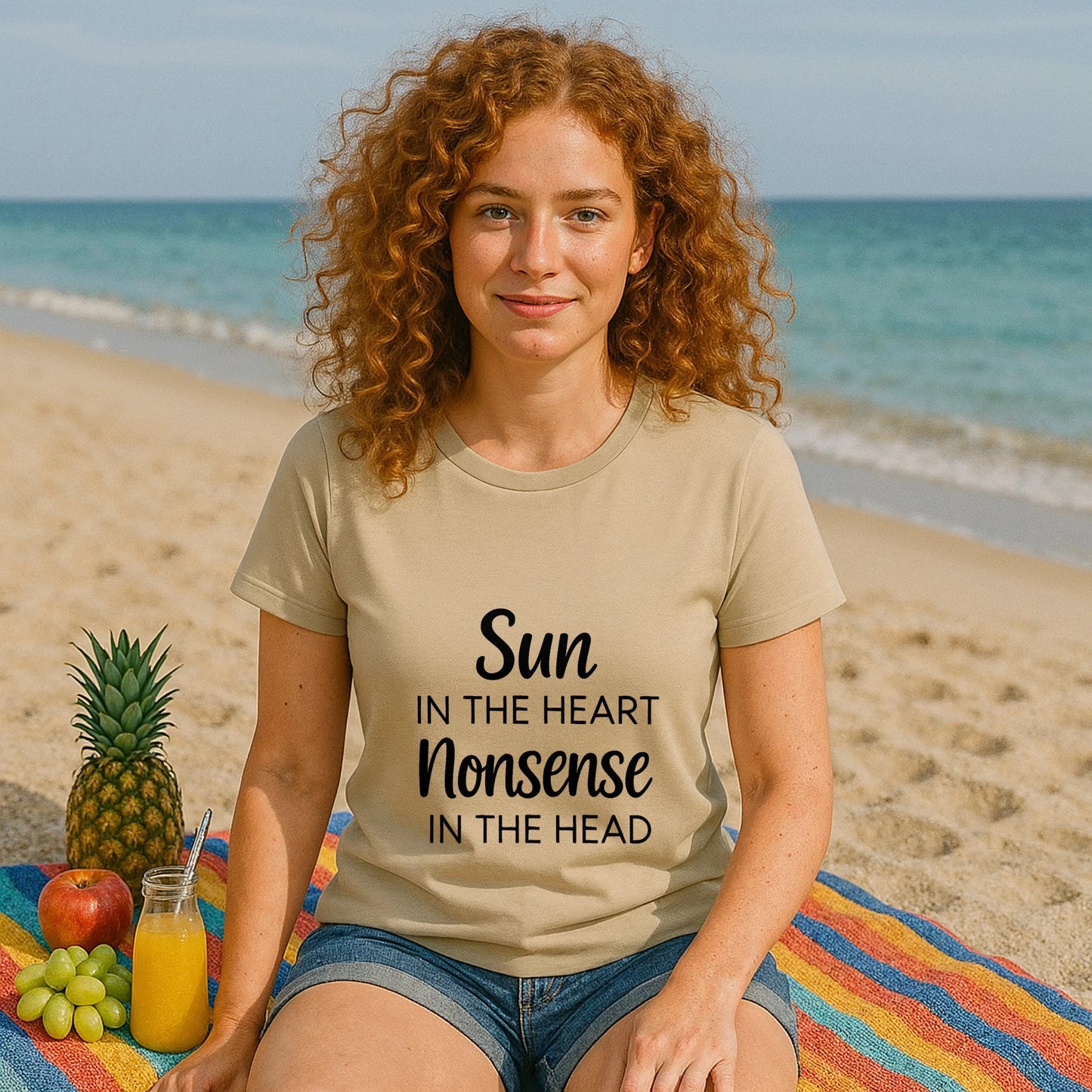 Organic Tee Sun in the Heart Nonsense in the Head beige organic cotton graphic t-shirt worn by woman on beach