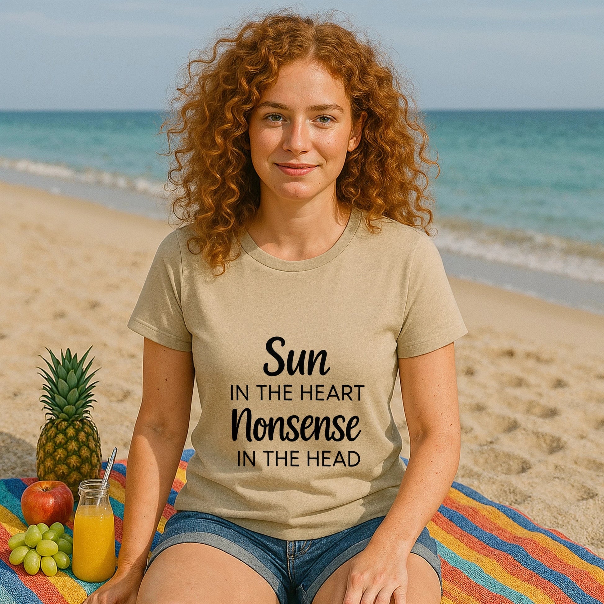 Organic Tee Sun in the Heart Nonsense in the Head beige organic cotton graphic t-shirt worn by woman on beach