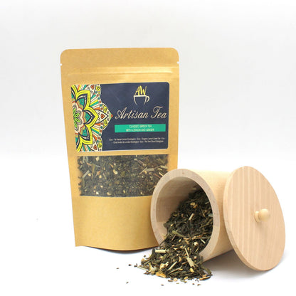 Alt Tag: Organic Green Tea – Lemon & Ginger Infusion 50G packaging with loose leaf tea and wooden canister on white background