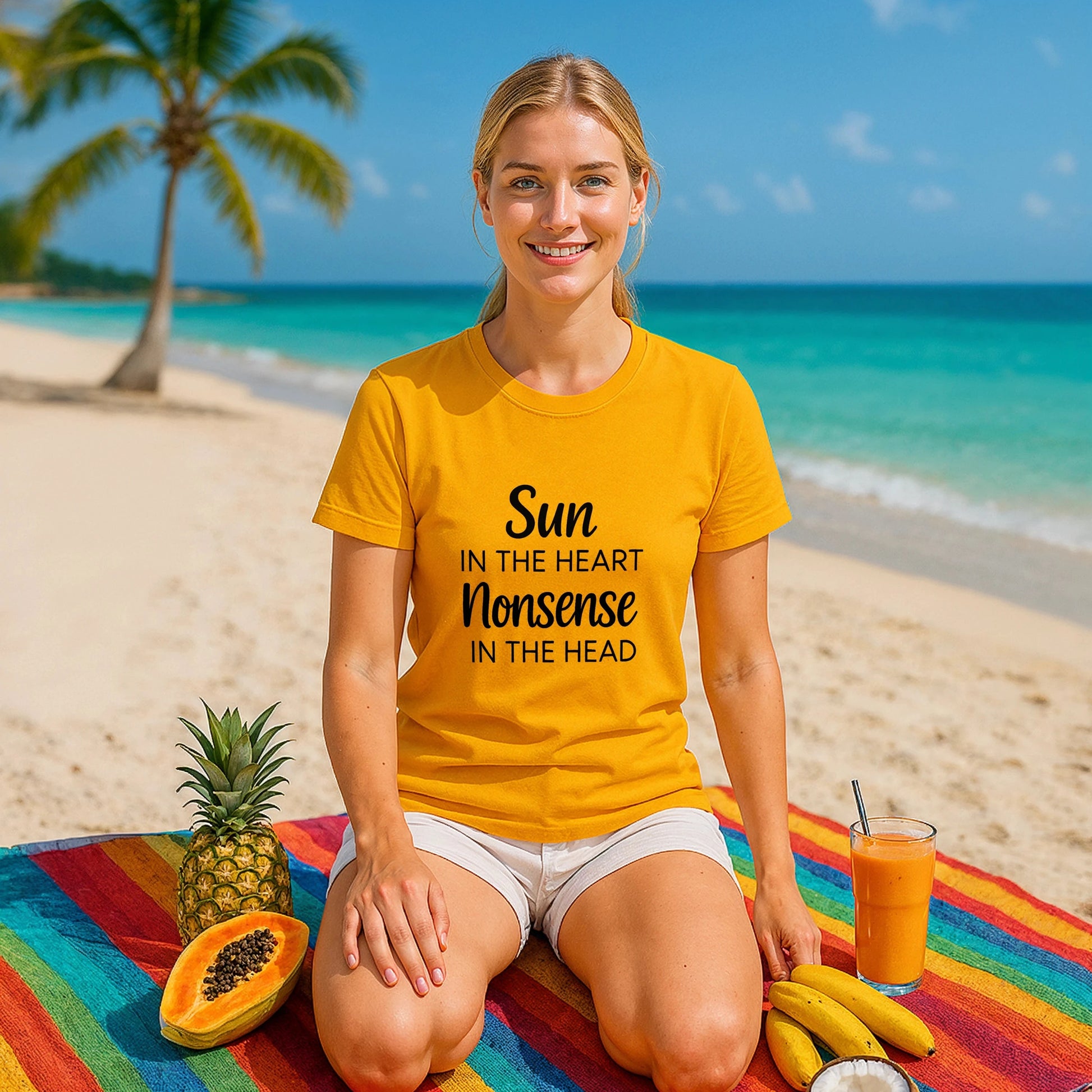 Organic Tee Sun in the Heart Nonsense in the Head yellow t-shirt on woman sitting on beach towel with tropical fruit
