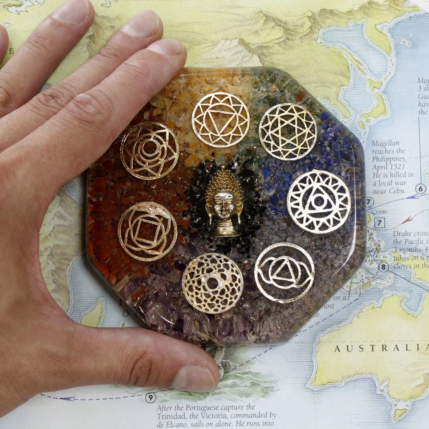 Alt Tag: Orgonite Desk Power Pack – Buddha Chakra – Large octagonal orgonite disk with Buddha center and seven chakra symbols, shown on map