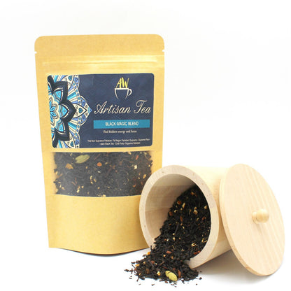 Pakistani Black Tea – Black Magic Blend 50G artisan tea pouch with loose leaf blend, cinnamon and orange peel, beside wooden tea caddy