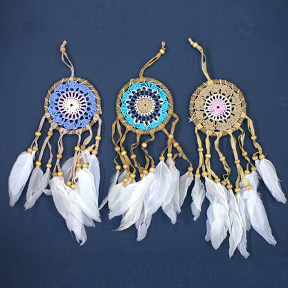 Alt Tag: Pastel Pink Cotton Dream Catcher – 9CM with handwoven cotton web, wooden beads and white feathers hanging on wall