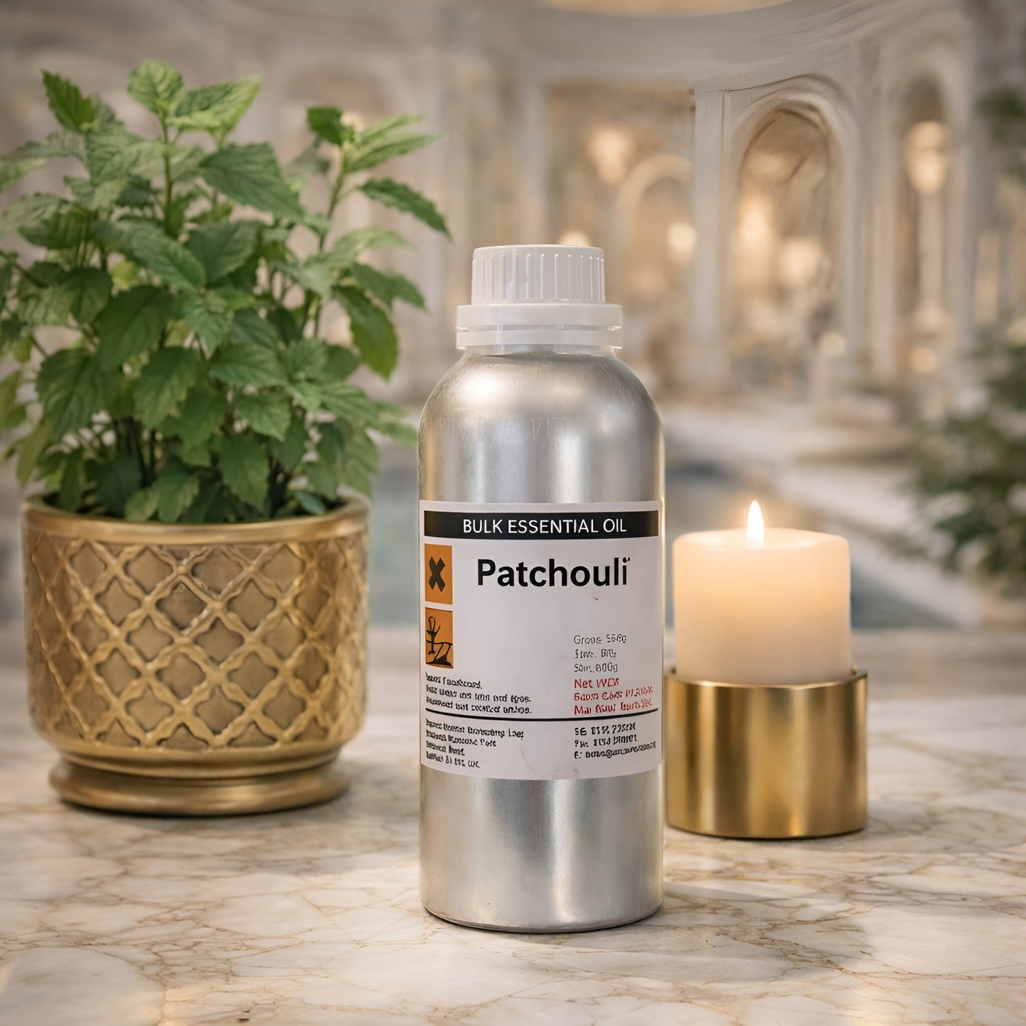 Patchouli Essential Oil – 500G Bulk bottle on marble table with candle and potted plant, bulk essential oil packaging