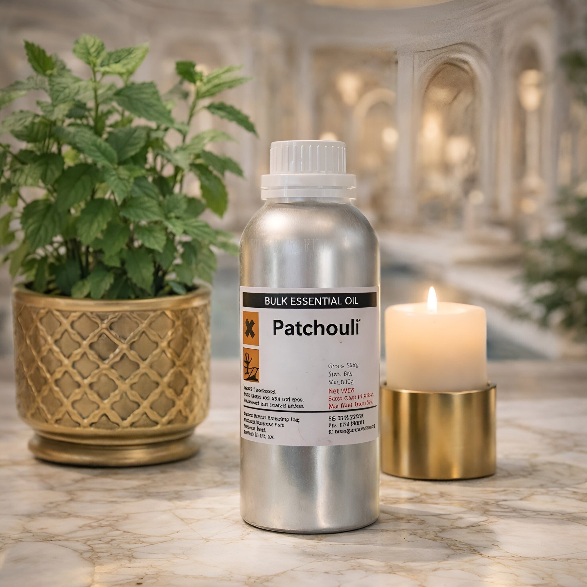 Patchouli Essential Oil – 500G Bulk bottle on marble table with candle and potted plant, bulk essential oil packaging