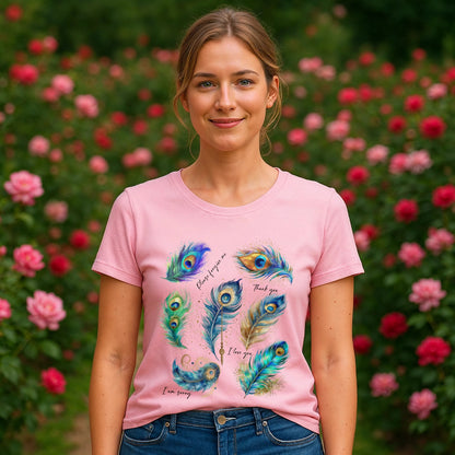 Peacock Hooponopono 100% Organic Cotton T-Shirt on model, pink tee with peacock feather graphic, outdoors