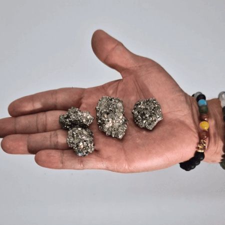 Alt Tag: Peruvian Pyrite – Medium Rare Gemstone, 200G, 35-50mm golden pyrite mineral specimens displayed on a hand