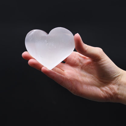 Alt Tag: Polished Selenite Heart – 5-6 CM translucent white crystal heart in hand, polished selenite stone decor piece