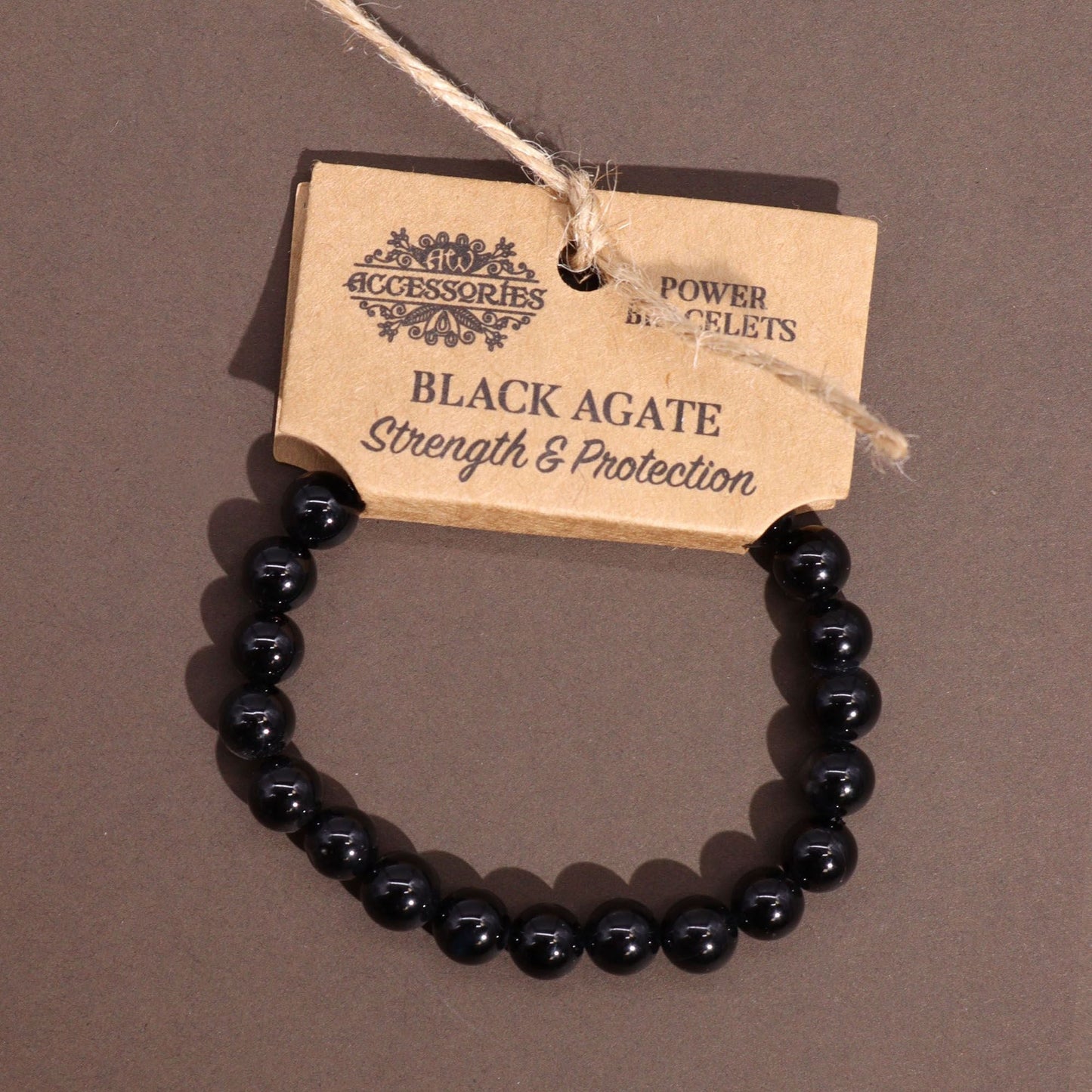 Power Bracelet – Black Agate black agate bead bracelet, polished round gemstone beads, product tag on gray background