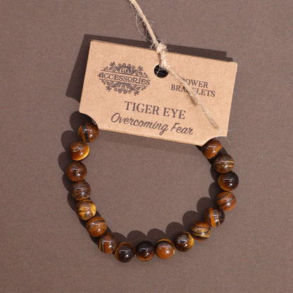 Alt Tag: Power Bracelet - Tiger Eye de cuentas de piedra ojo de tigre en tonos dorado y marrón, con etiqueta “TIGER EYE”