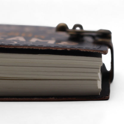 Alt Tag: Close-up of Printed Leather Notebook – 17.8 × 12.7 CM Never Give Up On Your Dreams showing pages and leather cover edge