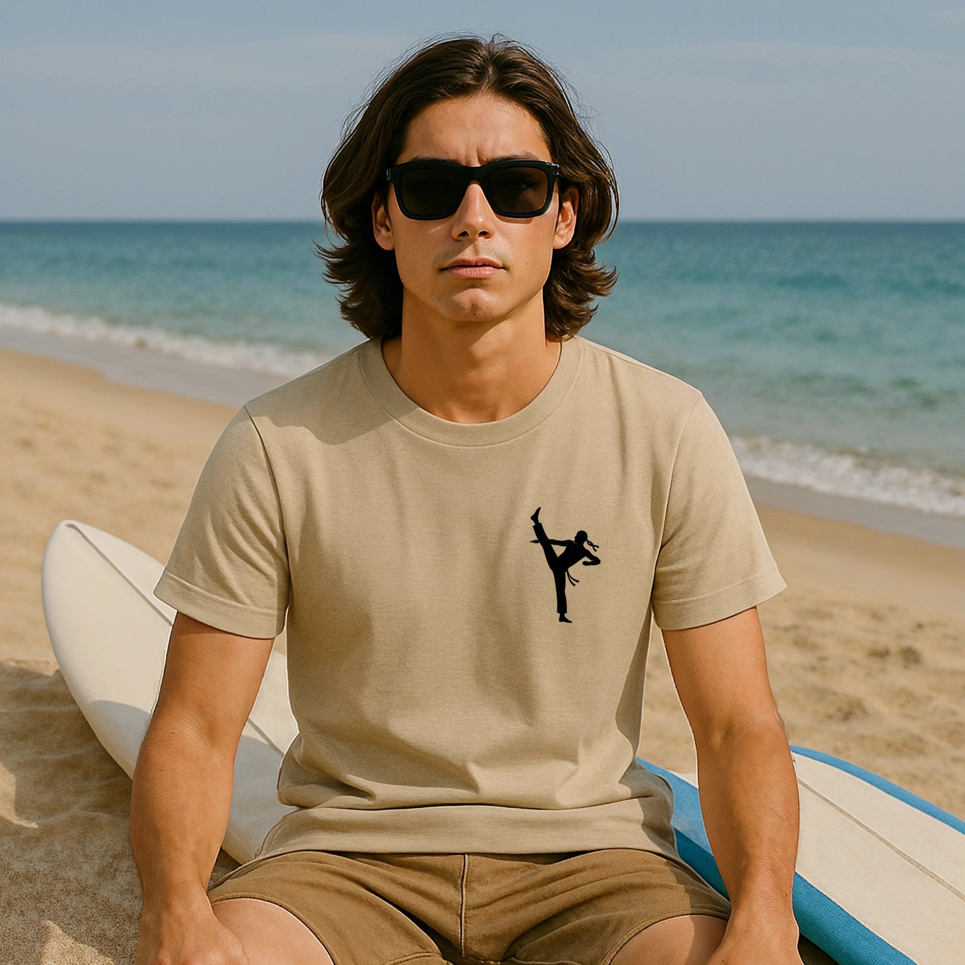Alt Tag: Professional Karate 100% Organic Cotton T-Shirt beige with karate kick graphic, worn by model sitting on beach