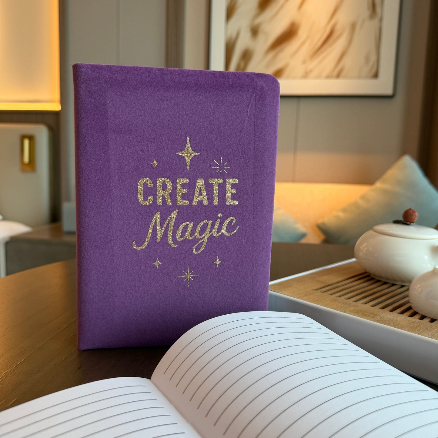 Alt Tag: Purple Velvet Notebook – 80 Pages- Create Magic, purple velvet “Create Magic” notebook with gold lettering, lined pages open on desk