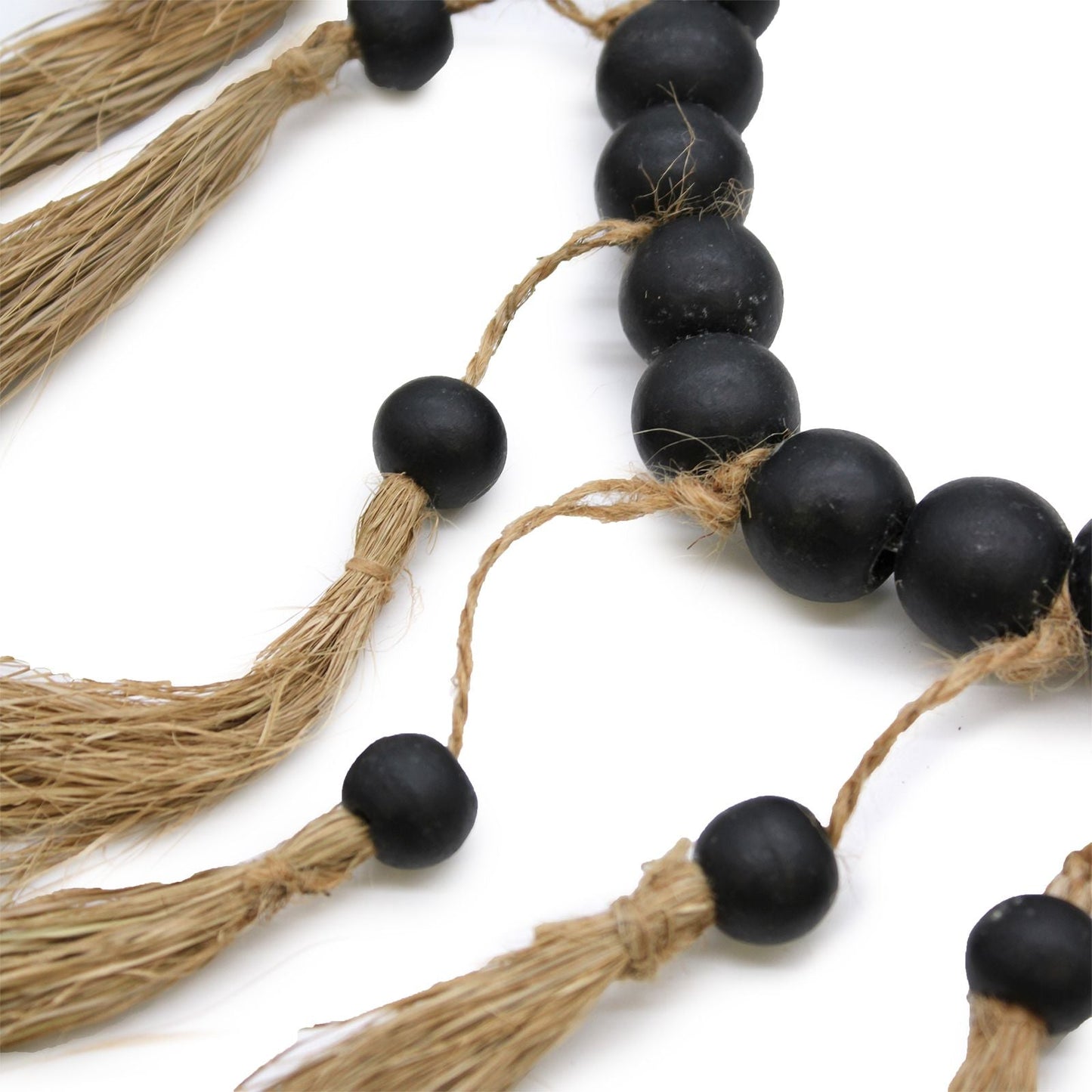 Raffia & Pinewood Bead Heart Mobile – 33x23 CM close-up of matte black pinewood beads and raffia tassels on natural twine