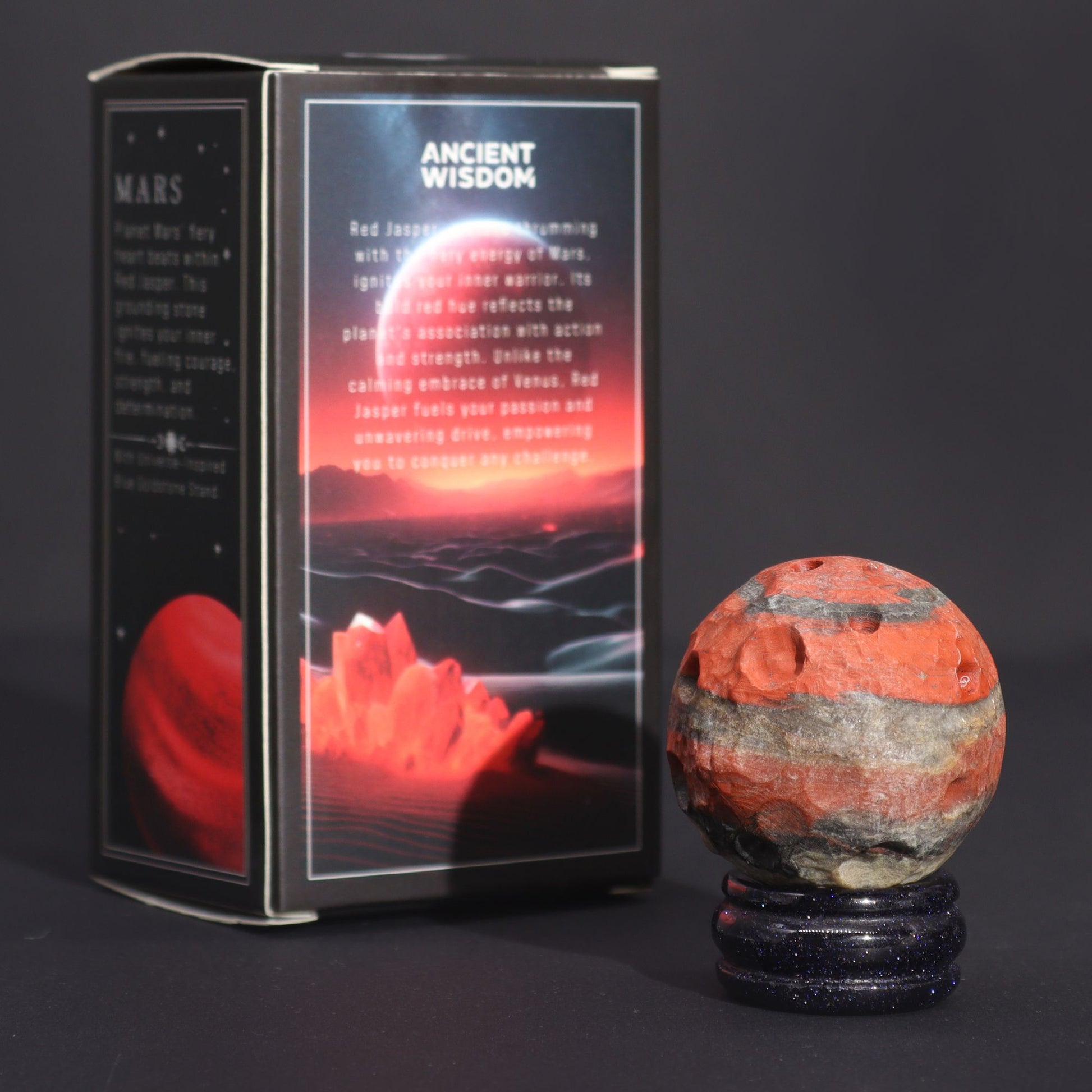 Red Jasper Mars Gemstone Sphere – 40MM on goldstone stand beside Ancient Wisdom Mars-themed box, red jasper gemstone sphere product photo
