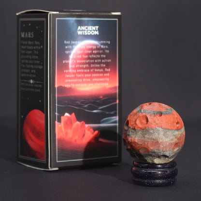 Red Jasper Mars Gemstone Sphere – 40MM on goldstone stand beside Ancient Wisdom Mars-themed box, red jasper gemstone sphere product photo