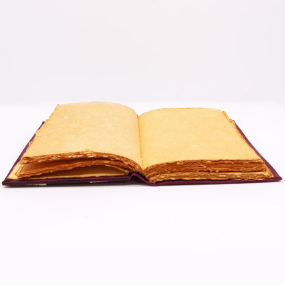 Red Tan Leather Journal – Zinc Hamsa 26x18CM open view showing blank aged paper pages on a flat surface