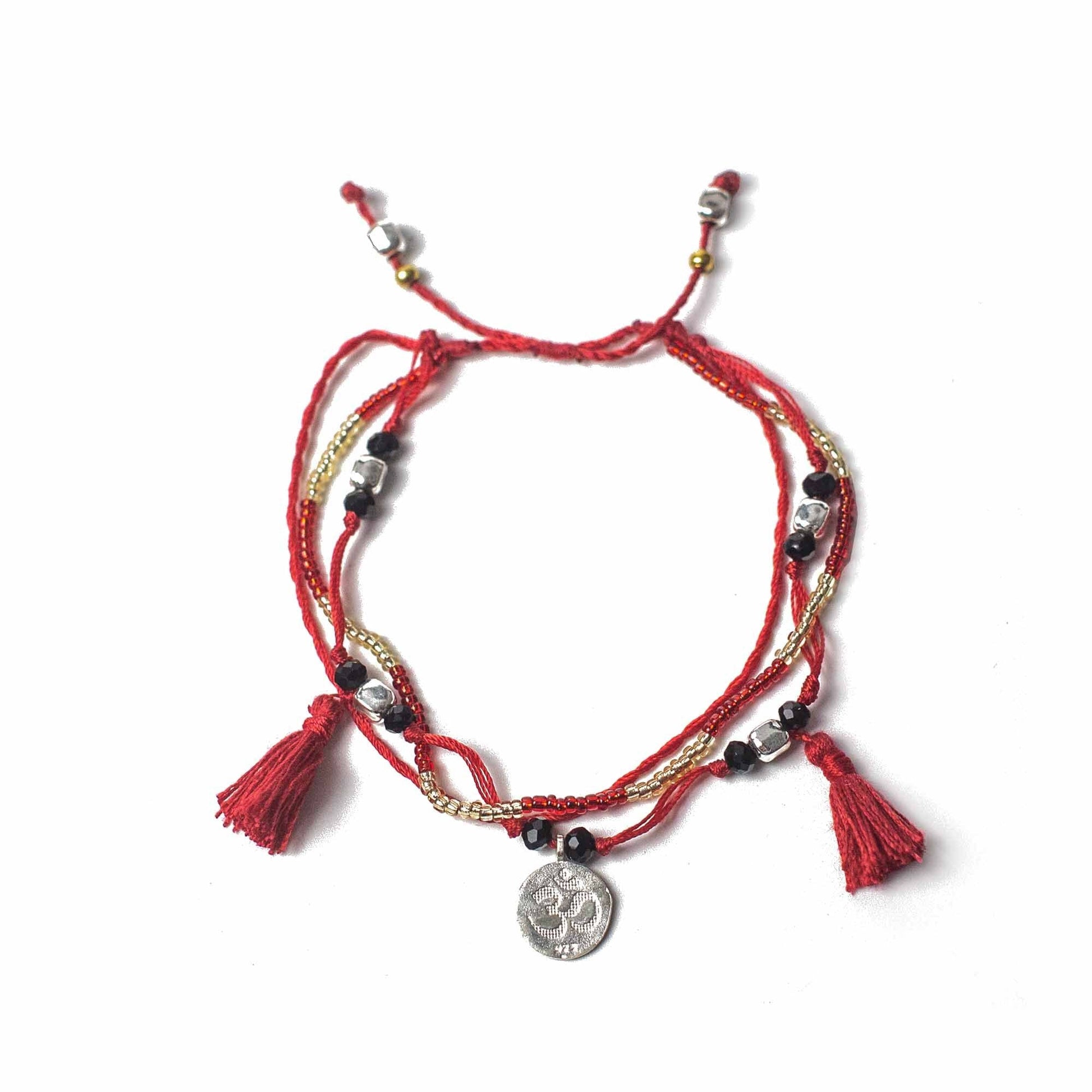 Alt Tag: Red Temple String Bracelet – Endless Knot bracelet in red string with beads, metal chain, tassels and Om charm, adjustable unisex