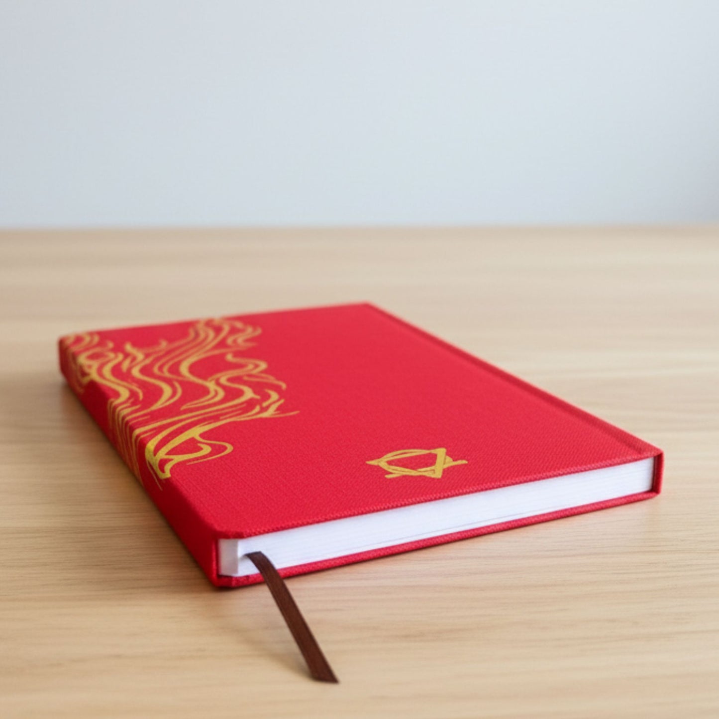 Alt Tag: Red Wellness Journal – 120 Pages – Golden Mandala & Lotus red hardcover journal with gold mandala design and ribbon bookmark on desk