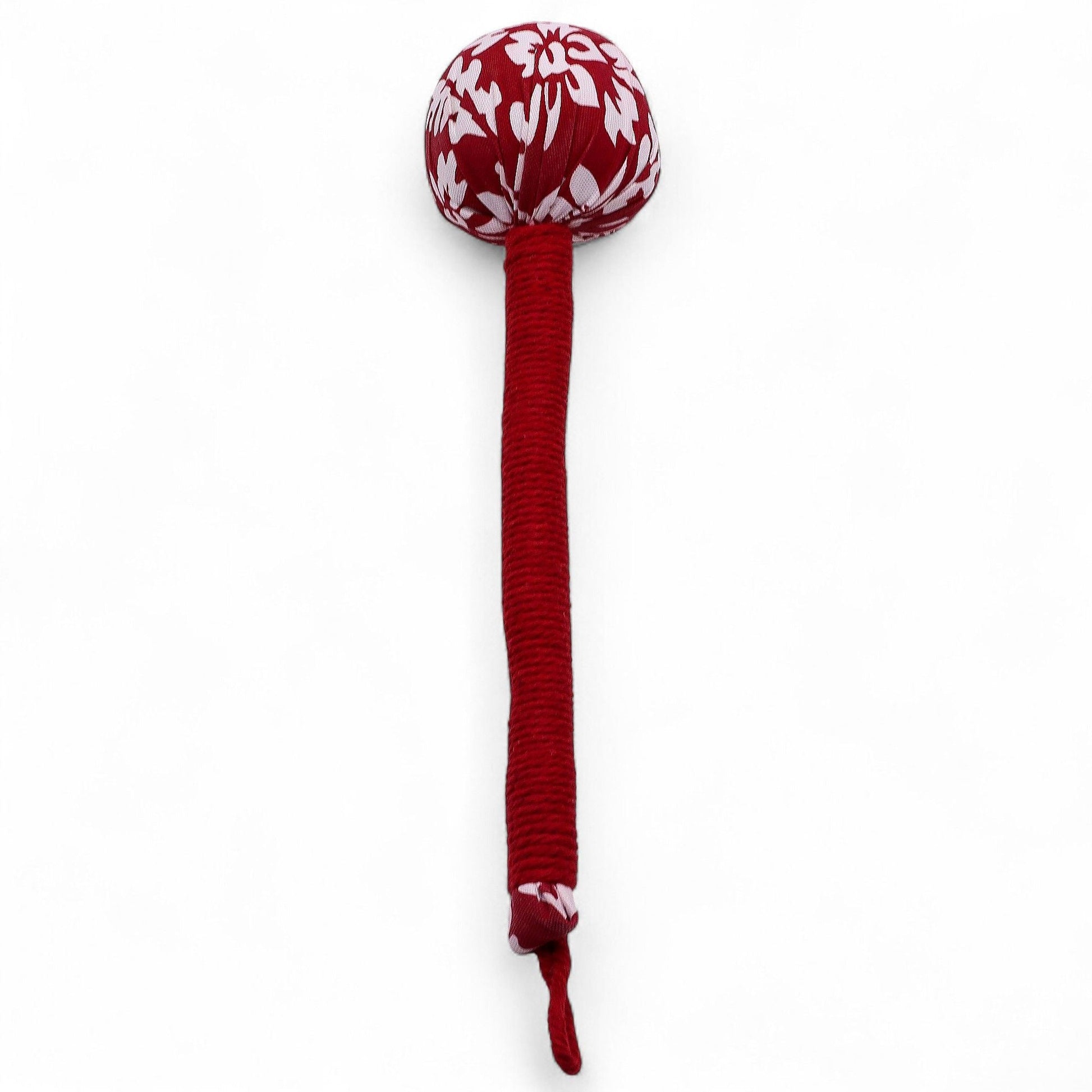 Alt Tag: Red Wormwood Massage Hammer – Wooden Tool with red wrapped wooden handle and patterned fabric head, hanging loop