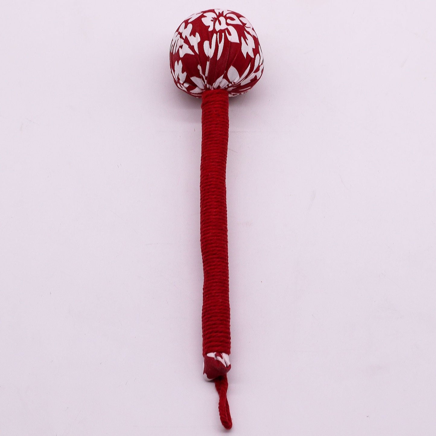 Alt Tag: Red Wormwood Massage Hammer – Wooden Tool with red wrapped handle and patterned head for rhythmic tapping massage